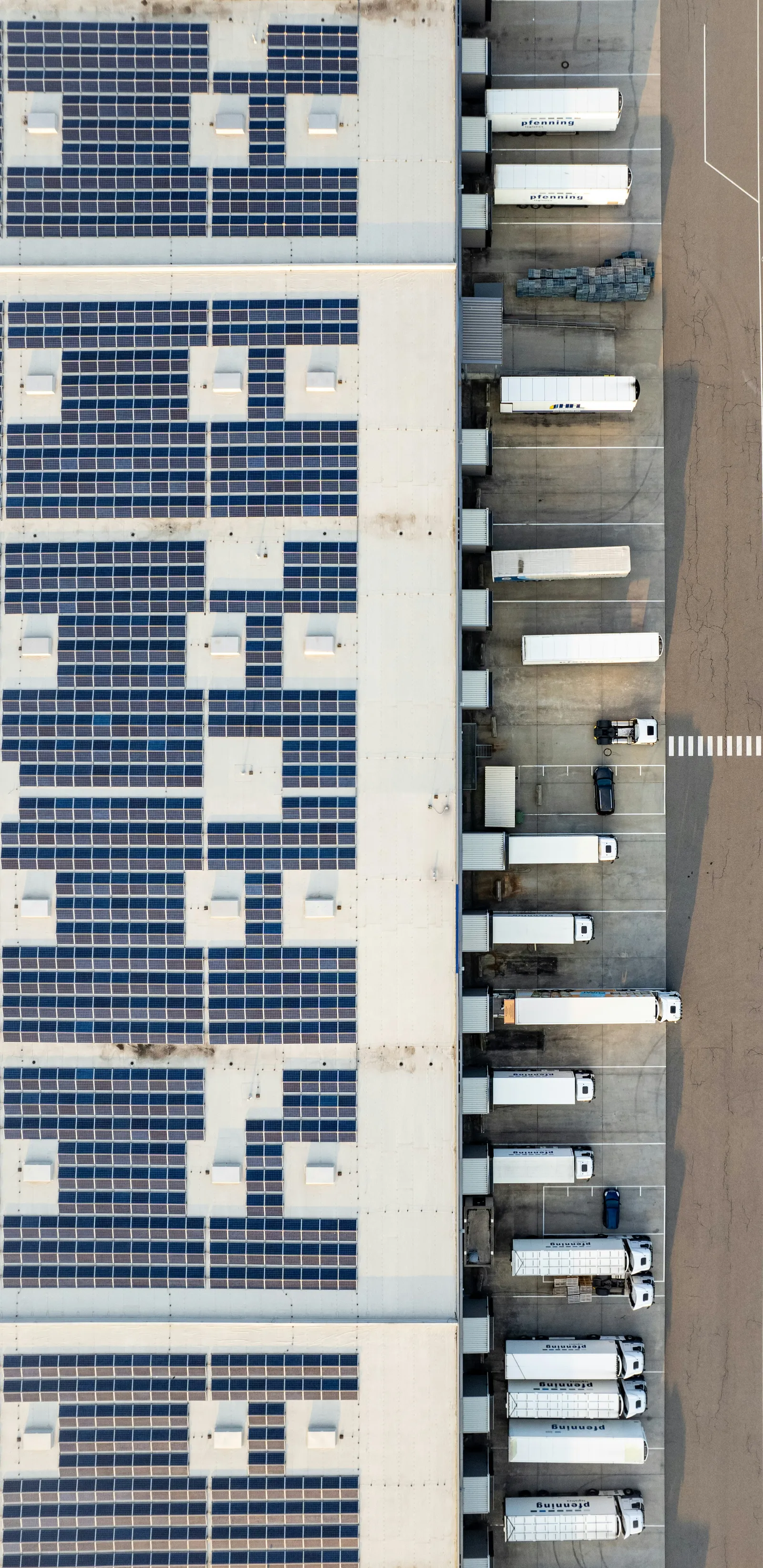 An aerial view of a building with a lot of solar panels